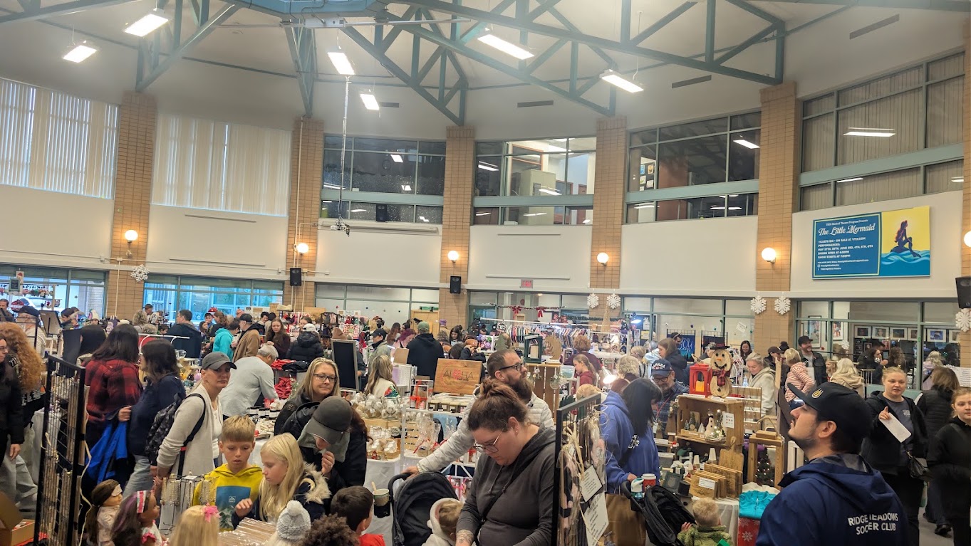 Visitors browsing craft stalls inside Thomas Haney Secondary’s Great Hall
