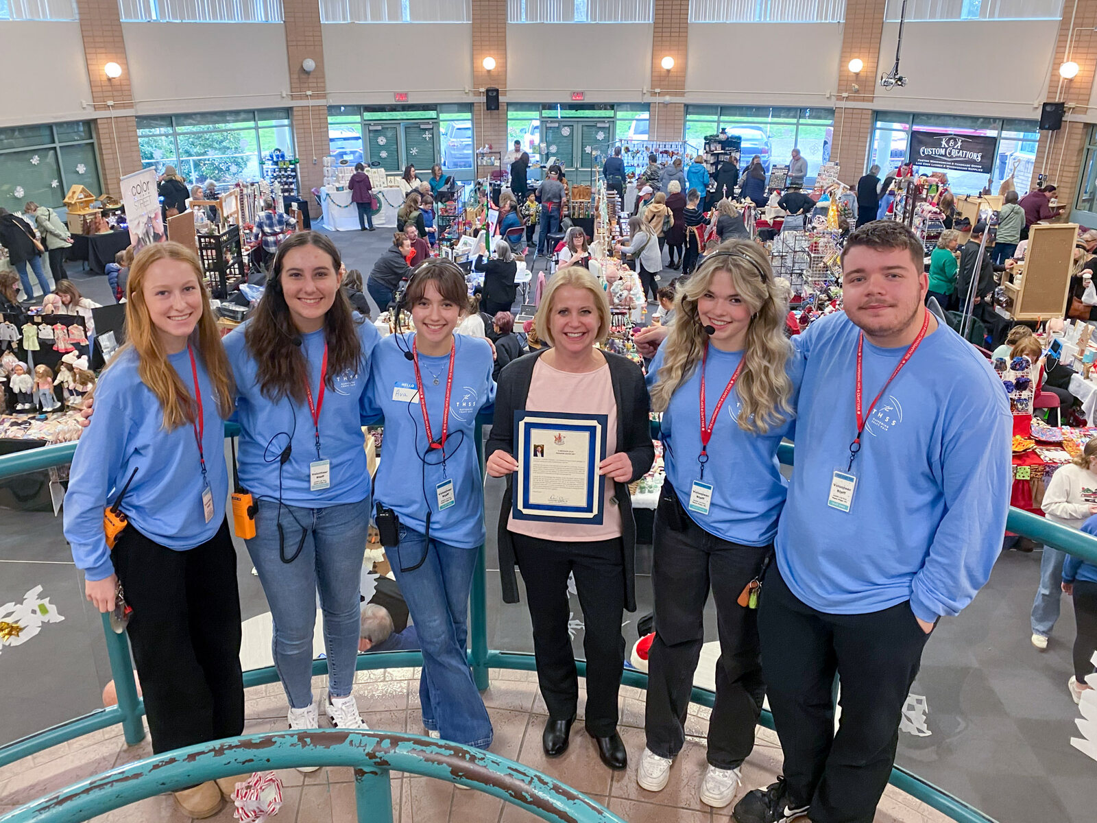 Members of the THSS craft fair team gathered above the busy Great Hall